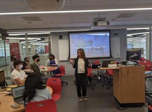 A woman talks to a room of students